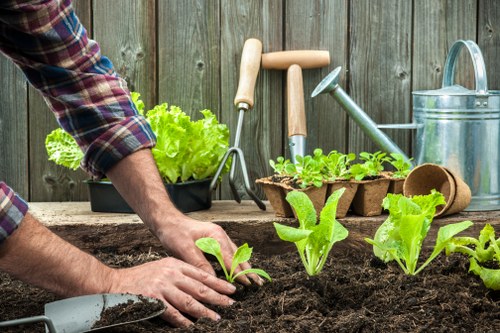 Crew performing sustainable garden maintenance in Edmonton with compost bins